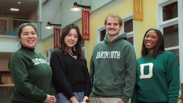 Four students smiling in Dartmouth gear