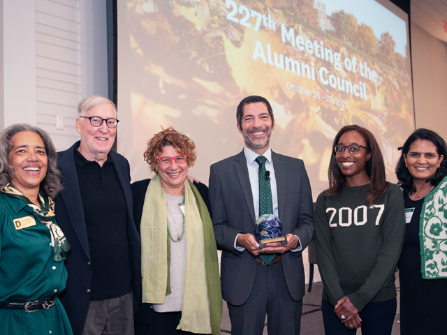 Alumni Council members standing at the front of the room at a meeting