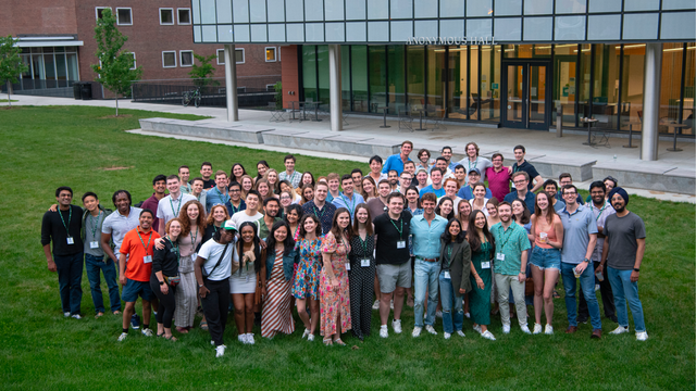 A group photo outside of Anonymous Hall.